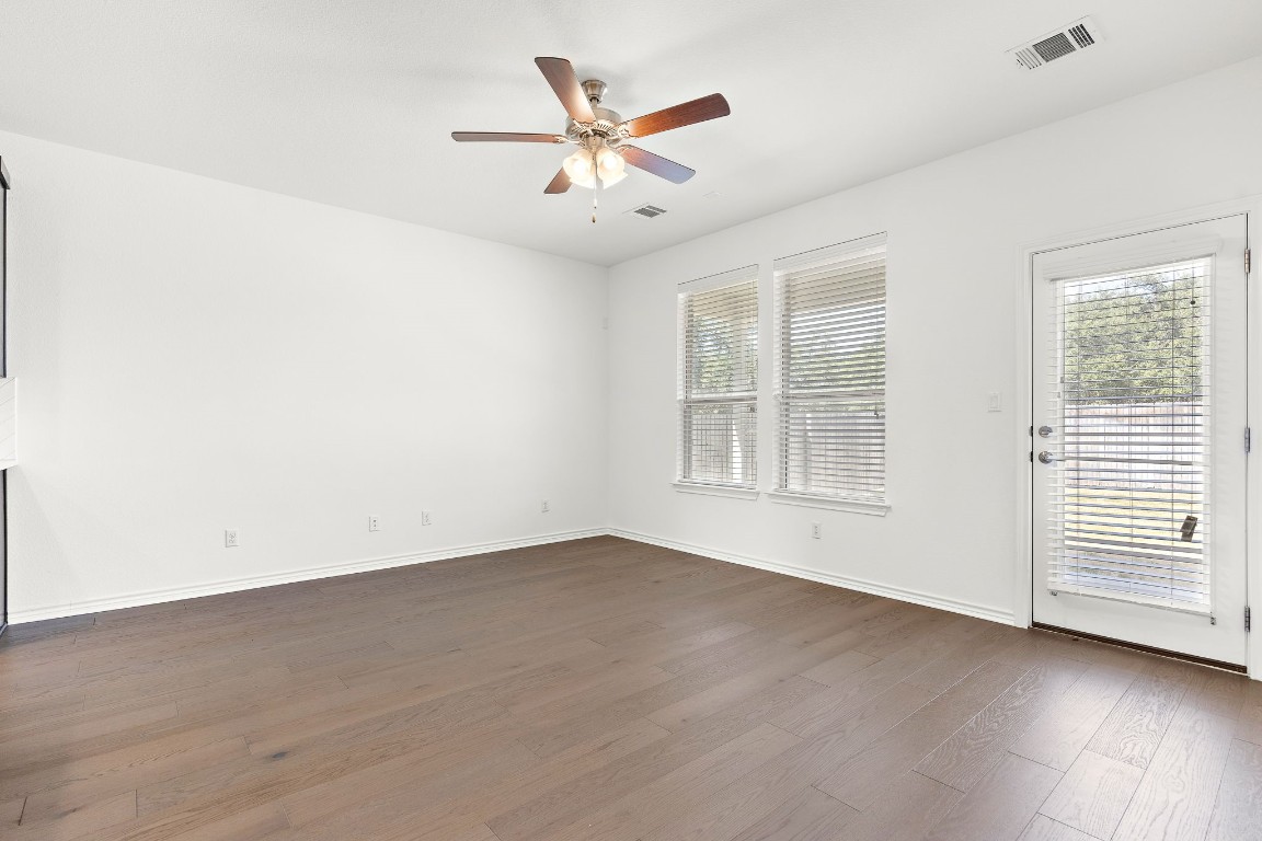 1817 Turtle Bay Loop Leander, TX 78641 - Photo 12 of 38 an empty room with wooden floor fan and windows