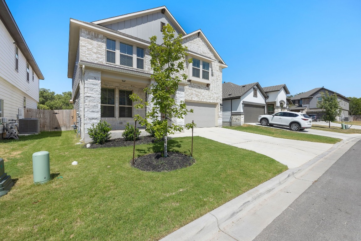1817 Turtle Bay Loop Leander, TX 78641 - Photo 2 of 38 a front view of a house with garden