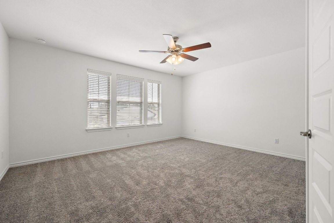 1817 Turtle Bay Loop Leander, TX 78641 - Photo 24 of 38 an empty room with windows and fan