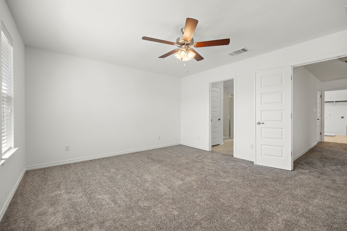 1817 Turtle Bay Loop Leander, TX 78641 - Photo 25 of 38 an empty room with closet and windows
