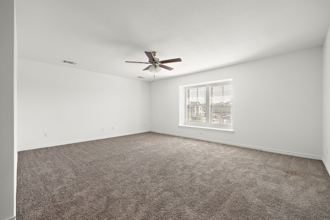 1817 Turtle Bay Loop Leander, TX 78641 - Photo 26 of 38 an empty room with windows and fan