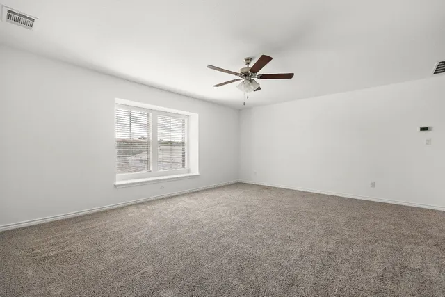 a view of room with hardwood floor and ceiling fan