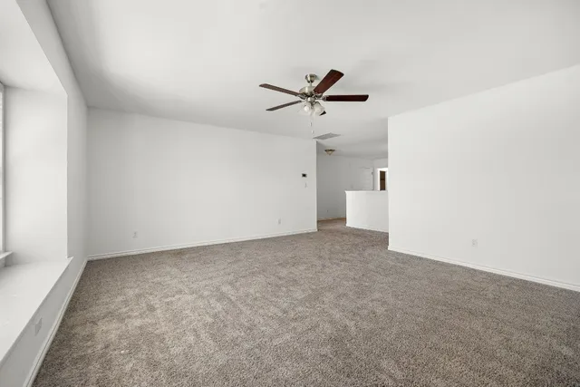 a view of empty room with ceiling fan