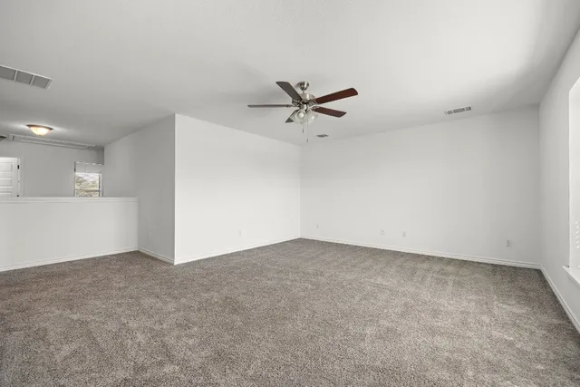 an empty room with closet and windows