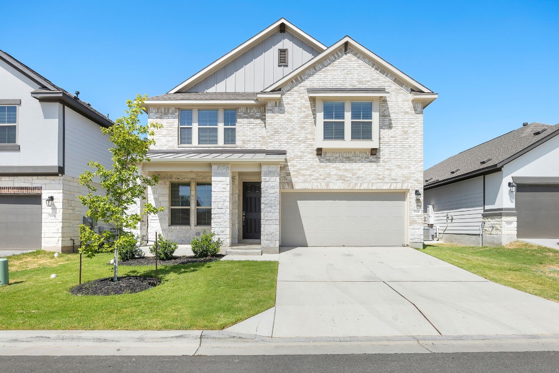 1817 Turtle Bay Loop Leander, TX 78641 - Photo 3 of 38 a front view of a house with a yard and garage