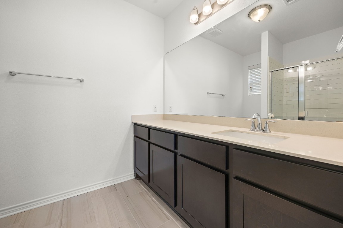 1817 Turtle Bay Loop Leander, TX 78641 - Photo 32 of 38 a bathroom with a sink and a mirror