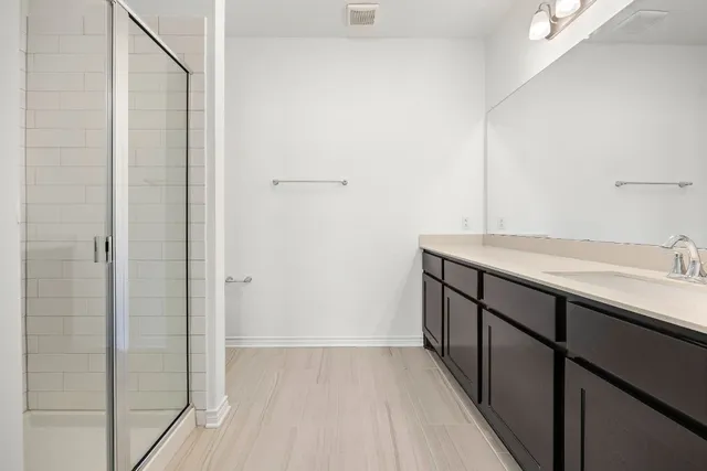 a bathroom with a double vanity sink and mirror