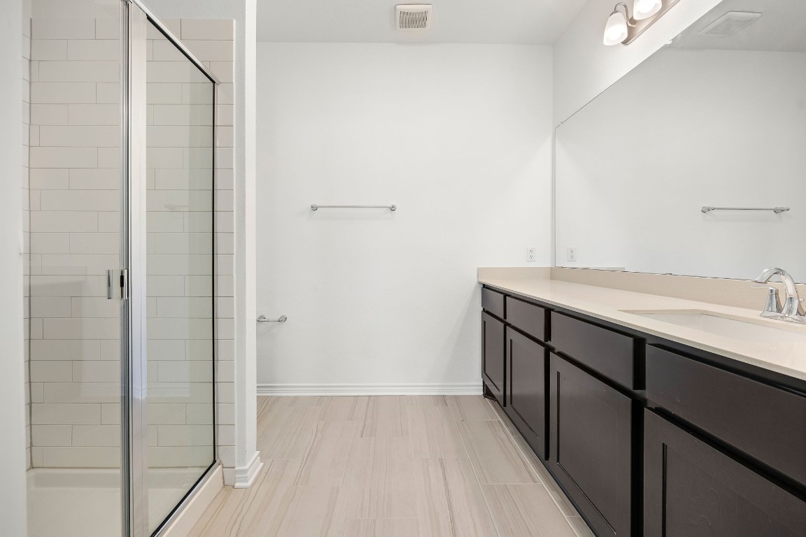1817 Turtle Bay Loop Leander, TX 78641 - Photo 34 of 38 a bathroom with a double vanity sink and mirror