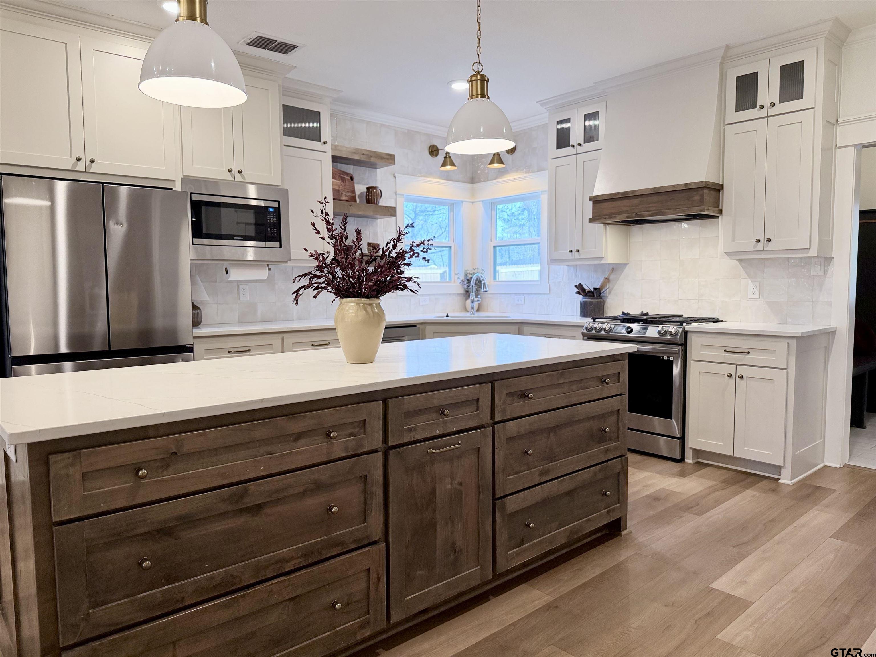 413 Dallas Street Winona, TX 75792 - Photo 13 of 33 a kitchen with stainless steel appliances granite countertop a sink stove and refrigerator