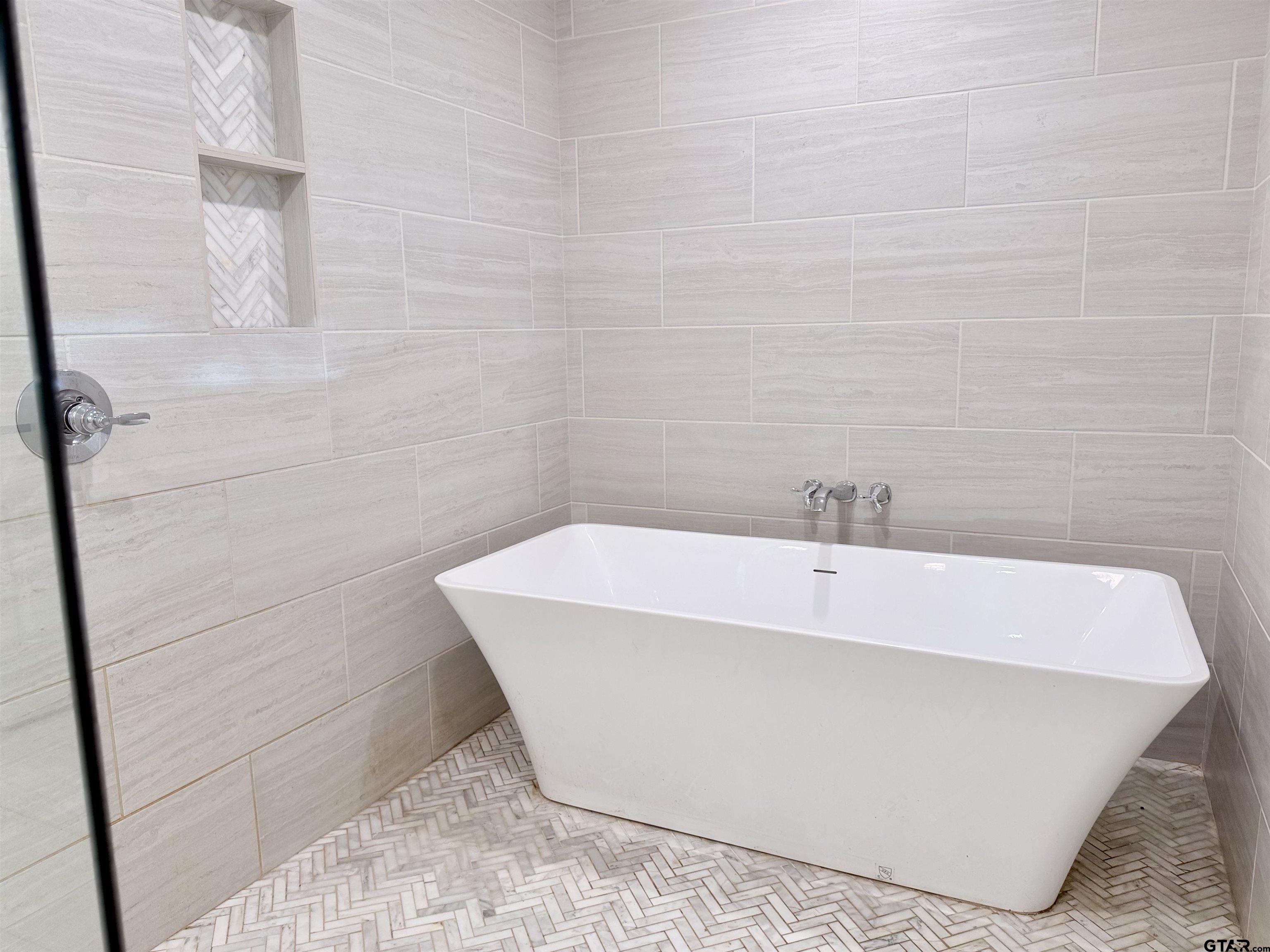 413 Dallas Street Winona, TX 75792 - Photo 16 of 33 a white bath tub sitting in a bathroom