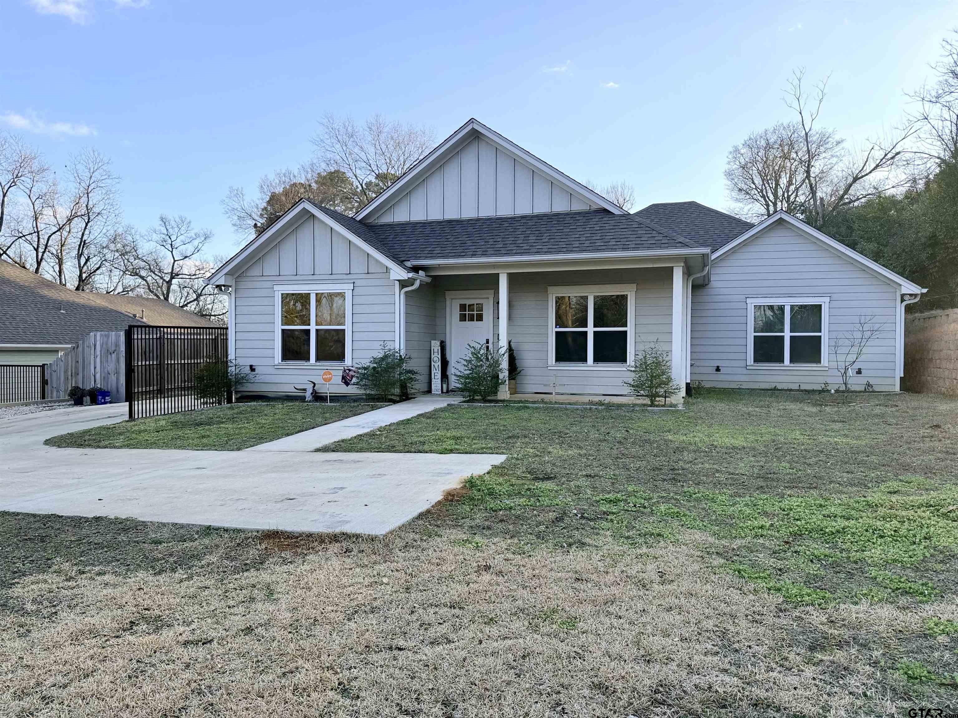 413 Dallas Street Winona, TX 75792 - Photo 9 of 33 a view of a yard in front of a house with large windows