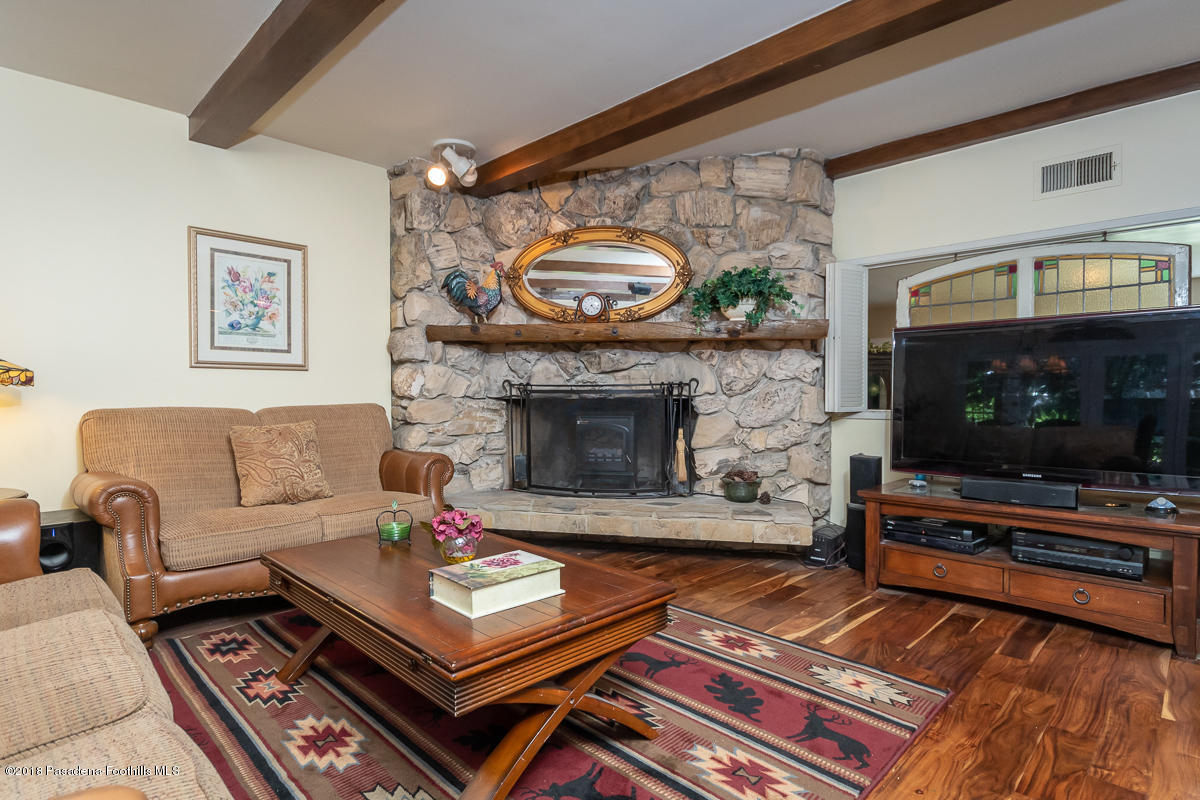 9624 Creemore Drive Tujunga, CA 91042 - Photo 11 of 56 a living room with furniture a flat screen tv and a fireplace