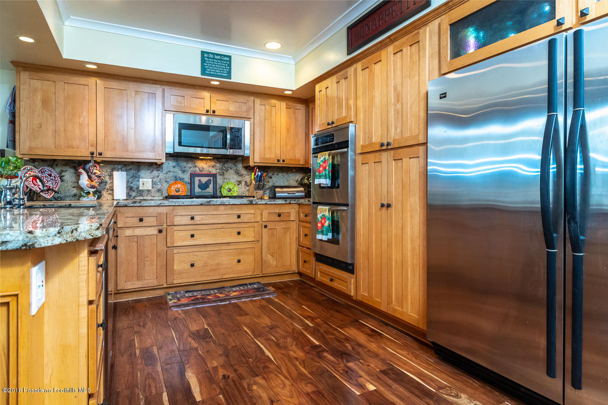 9624 Creemore Drive Tujunga, CA 91042 - Photo 16 of 56 a kitchen with stainless steel appliances a refrigerator and cabinets