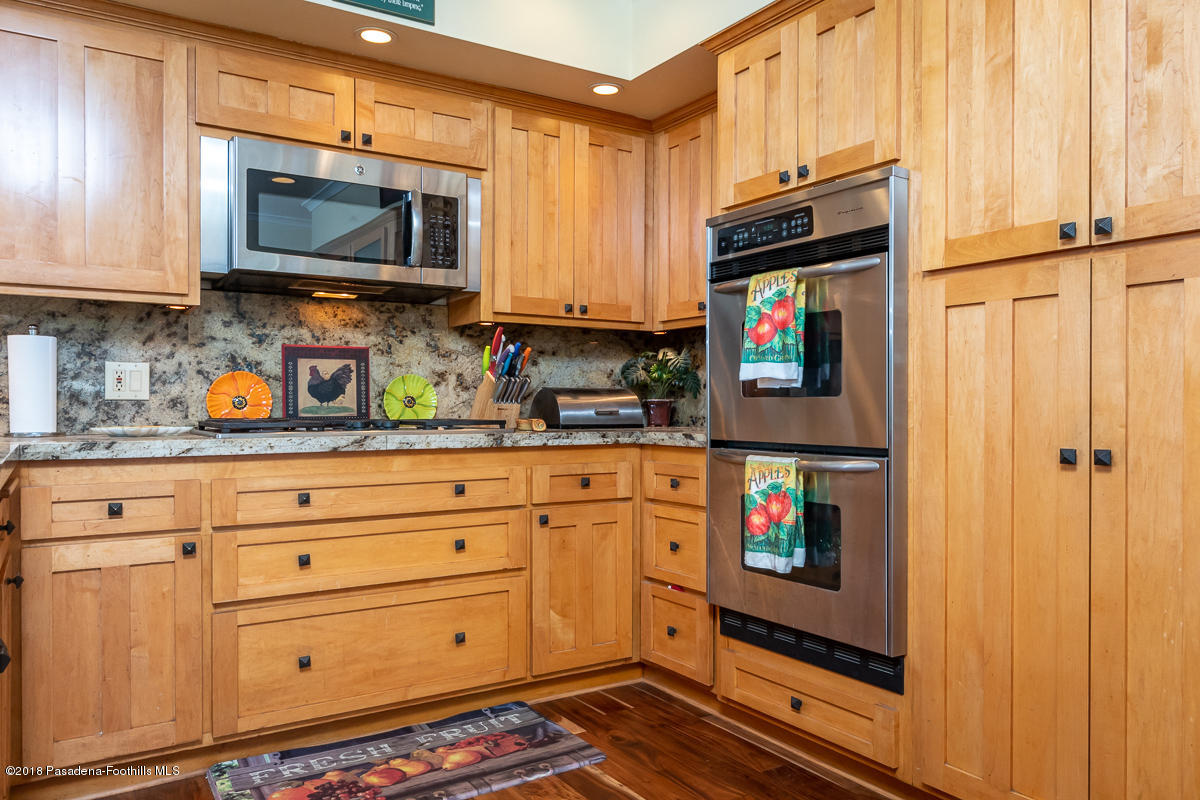 9624 Creemore Drive Tujunga, CA 91042 - Photo 17 of 56 a kitchen with stainless steel appliances a stove microwave and sink