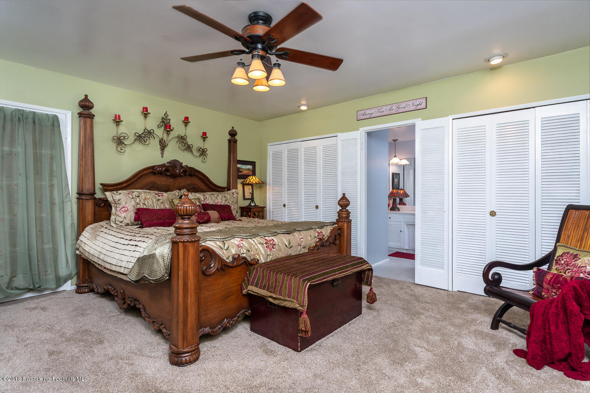 9624 Creemore Drive Tujunga, CA 91042 - Photo 22 of 56 a bedroom with a bed and a chandelier