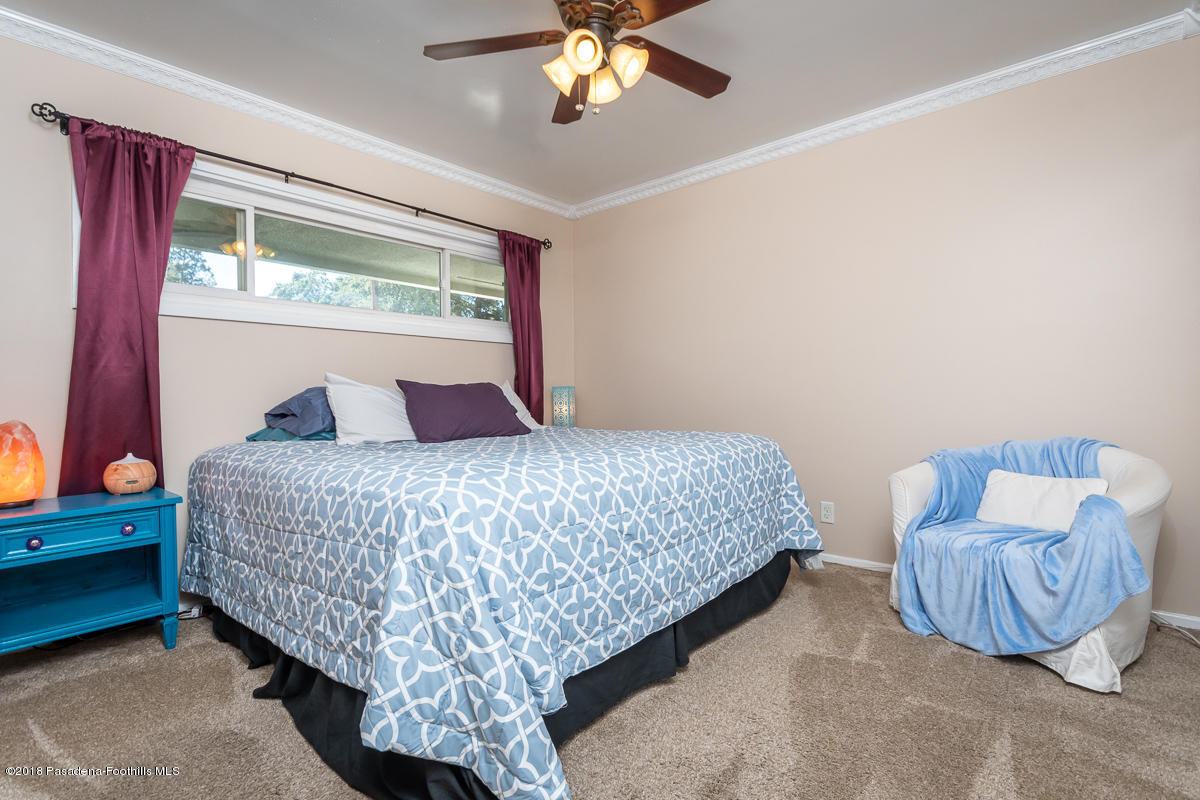 9624 Creemore Drive Tujunga, CA 91042 - Photo 29 of 56 a bedroom with a bed and a chandelier