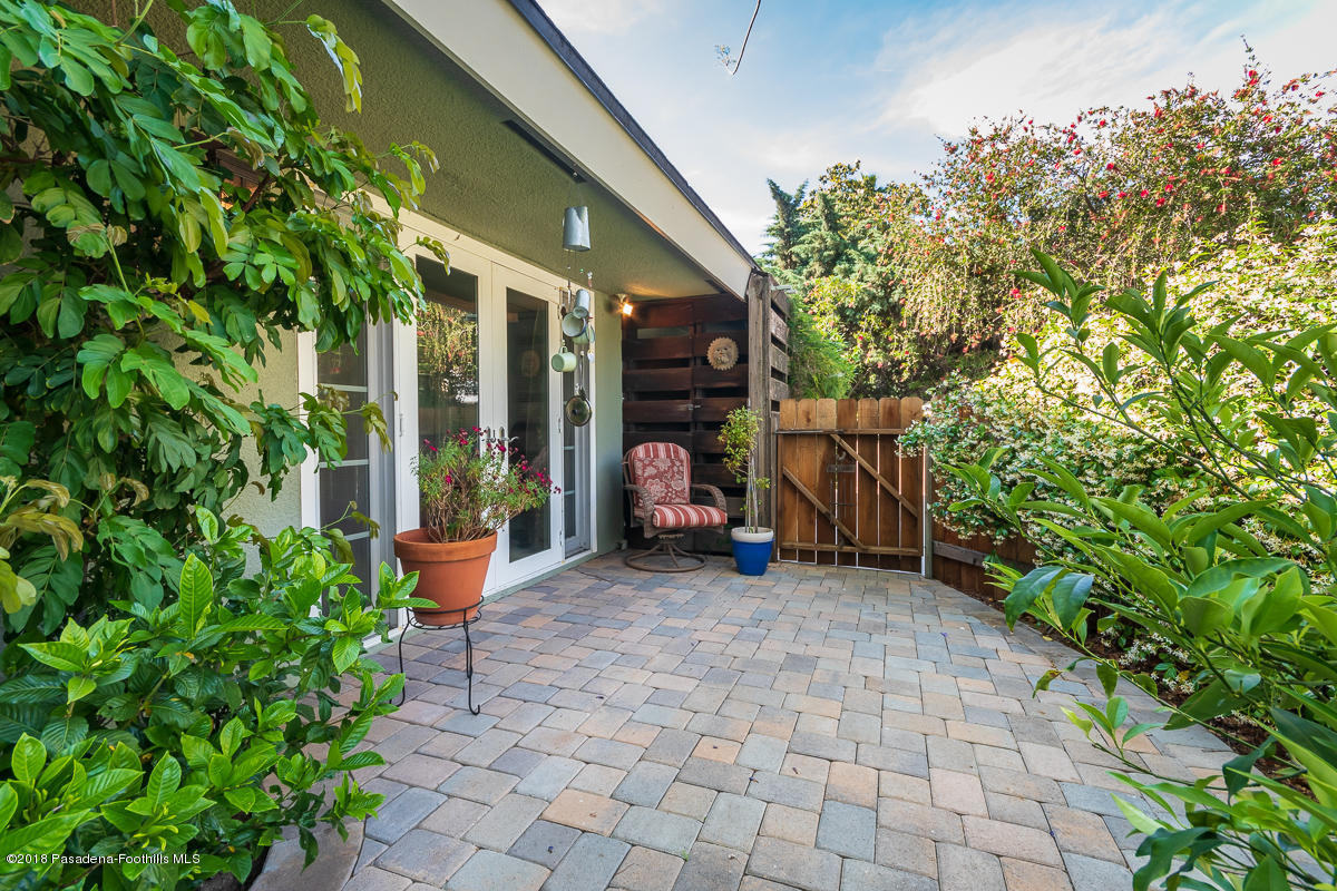 9624 Creemore Drive Tujunga, CA 91042 - Photo 44 of 56 a view of a chair and tables in the patio and a fountain