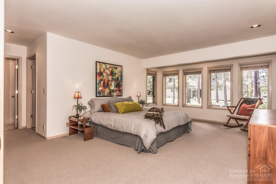 18035 North Course Lane Sunriver, OR 97707 - Photo 13 of 25 The large master suite is on the ground floor and includes spa-like double bathrooms and south facing windows to let the morning sun spill in.