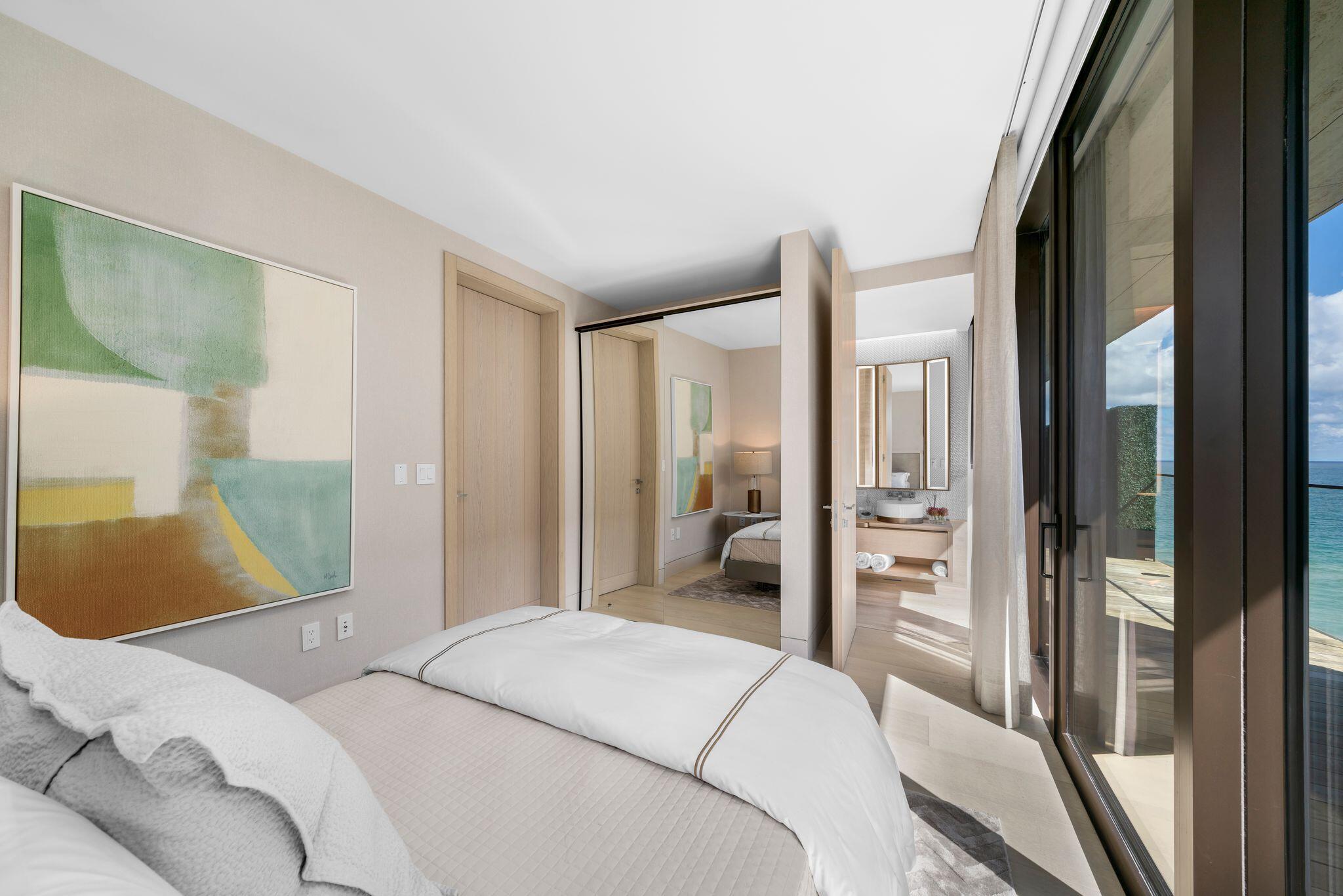 8955 Collins Avenue, Unit LPH Surfside, FL 33154 - Photo 32 of 40 a bedroom with a bed and a mirror