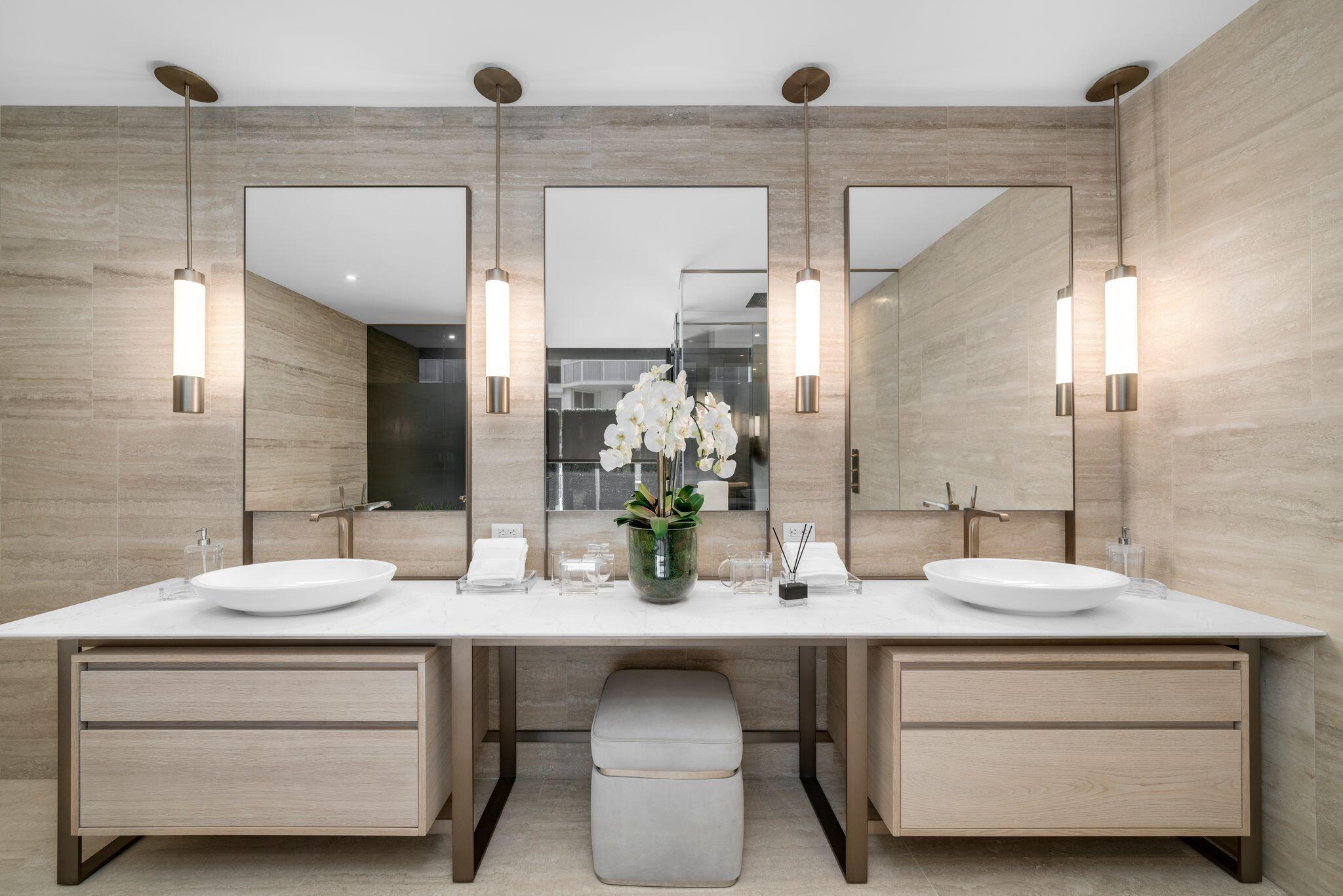 8955 Collins Avenue, Unit LPH Surfside, FL 33154 - Photo 8 of 40 a bathroom with a double vanity sink and a mirror