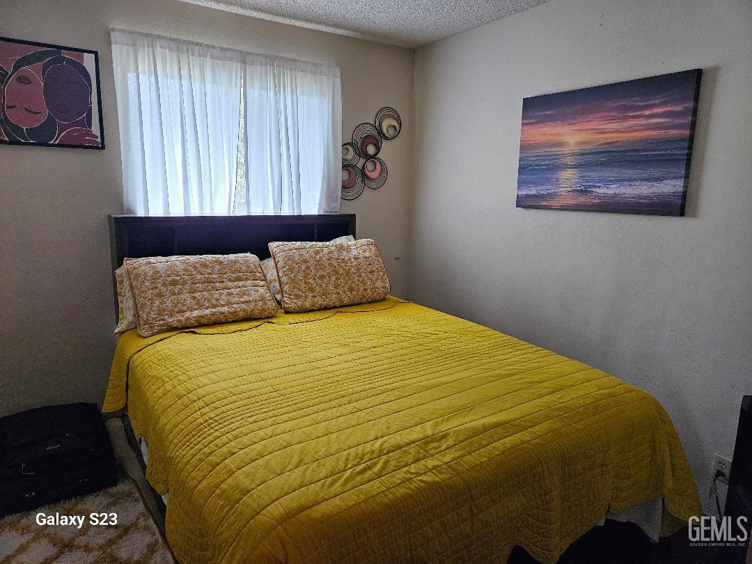 Undisclosed Address San Jose, CA 95111 - Photo 3 of 9 a bedroom with a bed and a painting on the wall