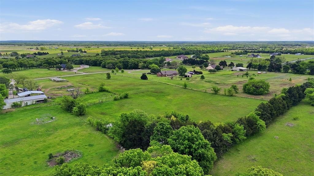 155 Basin Springs Road Sadler, TX 76264 - Photo 5 of 20 a view of a green field with houses in the background