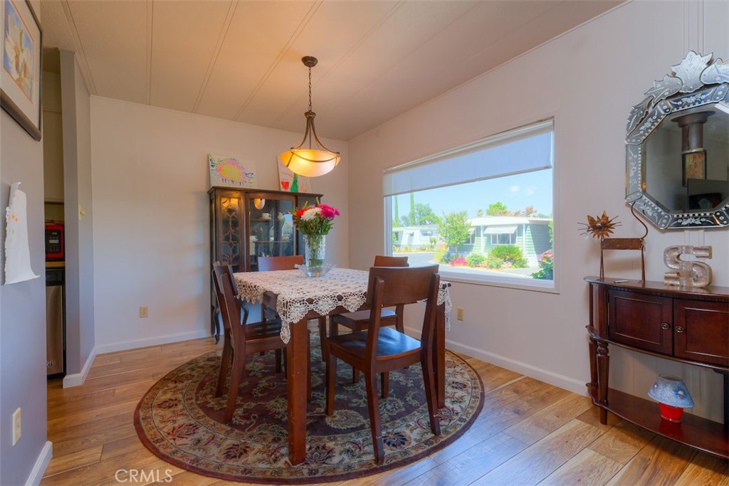 1901 Dayton Road, Unit 133 Chico, CA 95928 - Photo 9 of 36 a dining room with furniture a chandelier and wooden floor