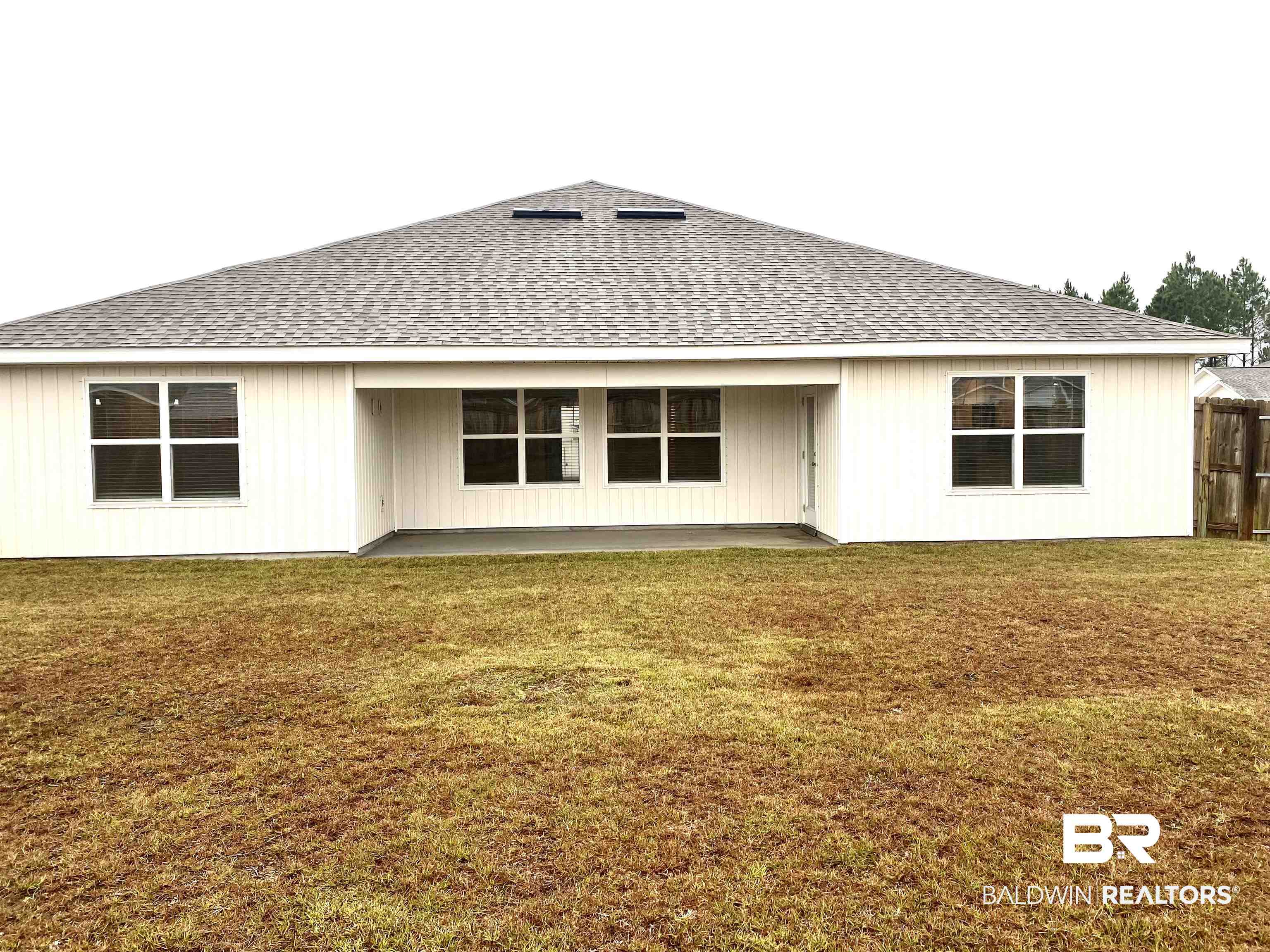 14496 Cavendish Drive Foley, AL 36535 - Photo 24 of 26 Rear view of property with a shingled roof, a lawn, and a patio