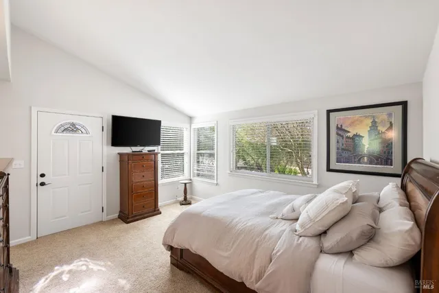 a bathroom with a sink a mirror a toilet and shower