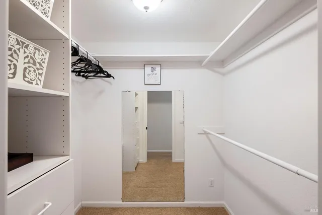 a bathroom with a toilet a sink a tub and a mirror