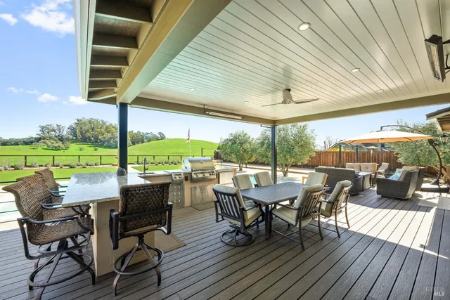 a view of a pool a fire pit and outdoor space