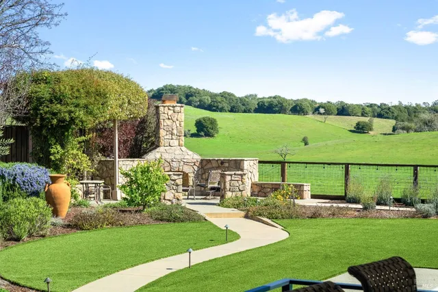 a view of a tennis ground with large trees