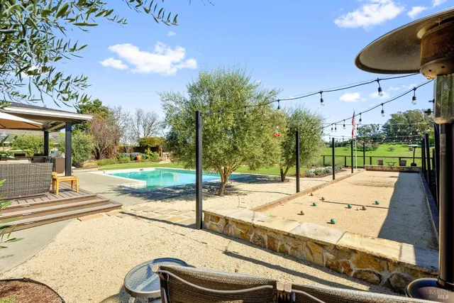 a backyard of a house with table and chairs