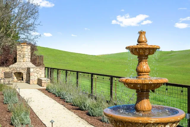 a swimming pool view with a seating space and a garden view
