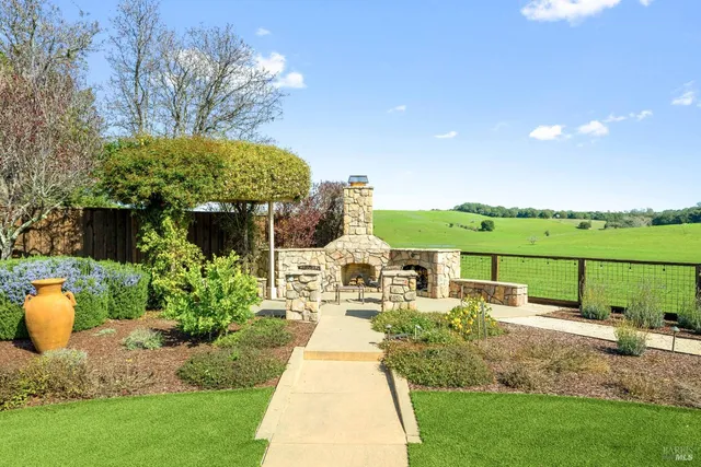 a view of a house with swimming pool and sitting area