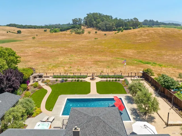 a view of a swimming pool with a yard