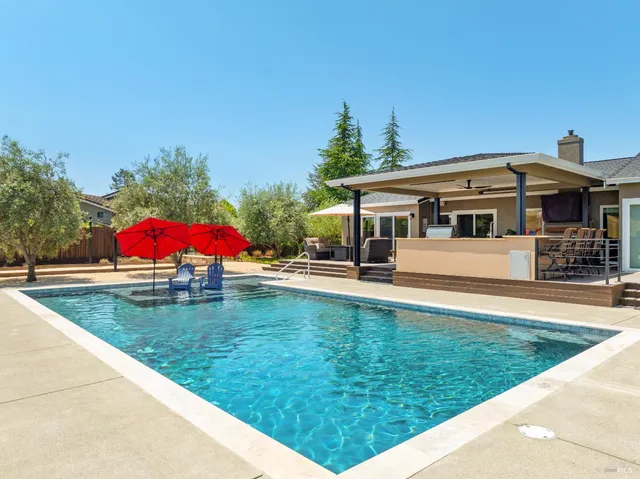 a large kitchen with a table and chairs