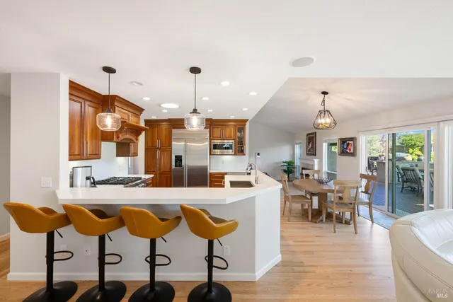 a kitchen with stainless steel appliances granite countertop a sink a stove and a refrigerator