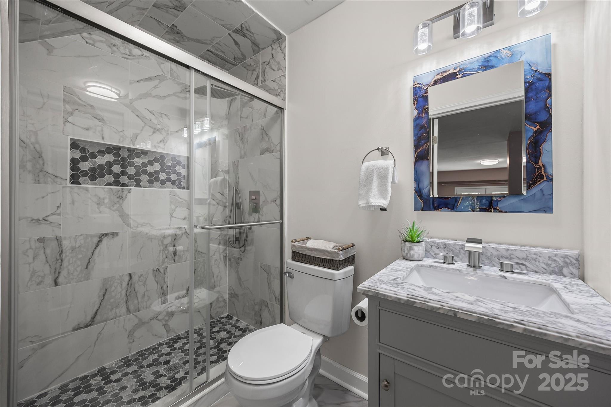 26003 Morningside Drive Fort Mill, SC 29708 - Photo 3 of 37 a bathroom with a granite countertop sink toilet a mirror and shower