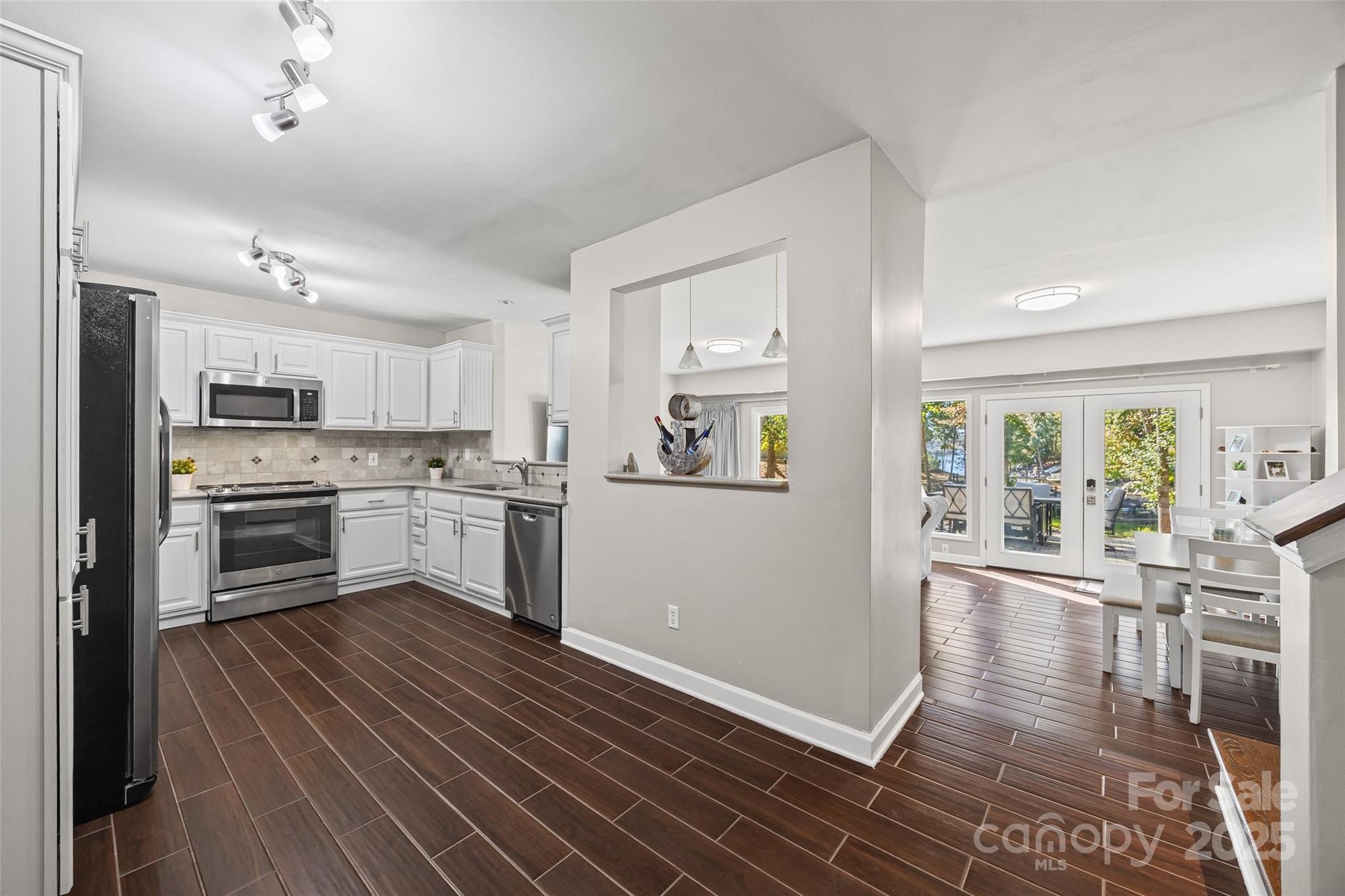 26003 Morningside Drive Fort Mill, SC 29708 - Photo 5 of 37 a kitchen with white cabinets and stainless steel appliances