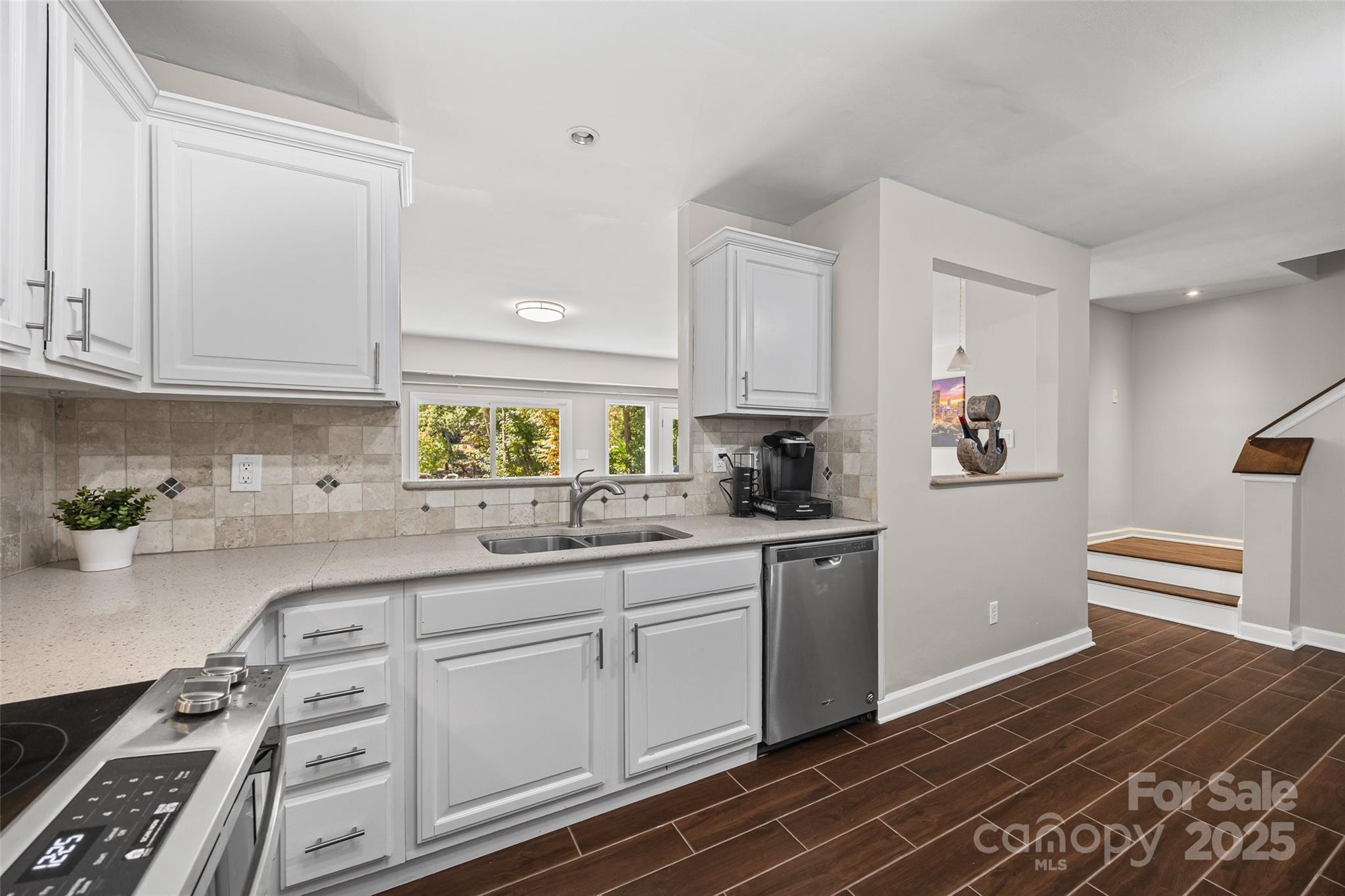 26003 Morningside Drive Fort Mill, SC 29708 - Photo 7 of 37 a kitchen with white cabinets and appliances
