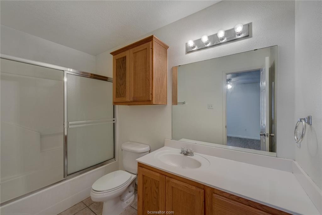 1715 Rock Hollow Loop Bryan, TX 77807 - Photo 11 of 13 a bathroom with a sink a toilet and shower