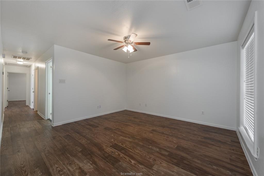 1715 Rock Hollow Loop Bryan, TX 77807 - Photo 2 of 13 wooden floor in an empty room with a window