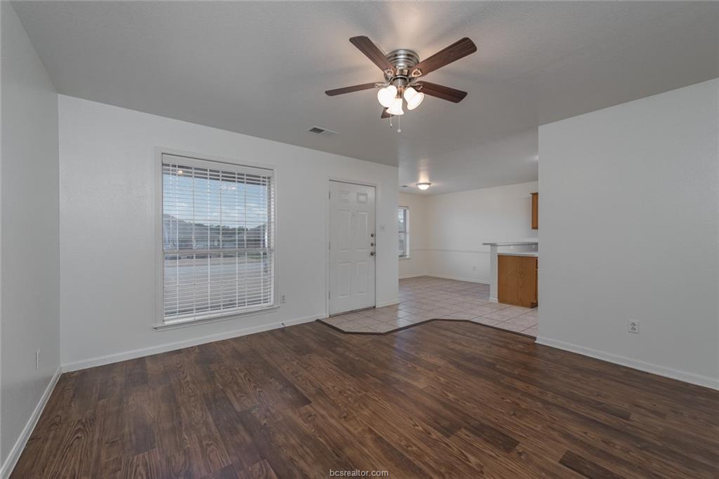 1715 Rock Hollow Loop Bryan, TX 77807 - Photo 3 of 13 an empty room with wooden floor and windows