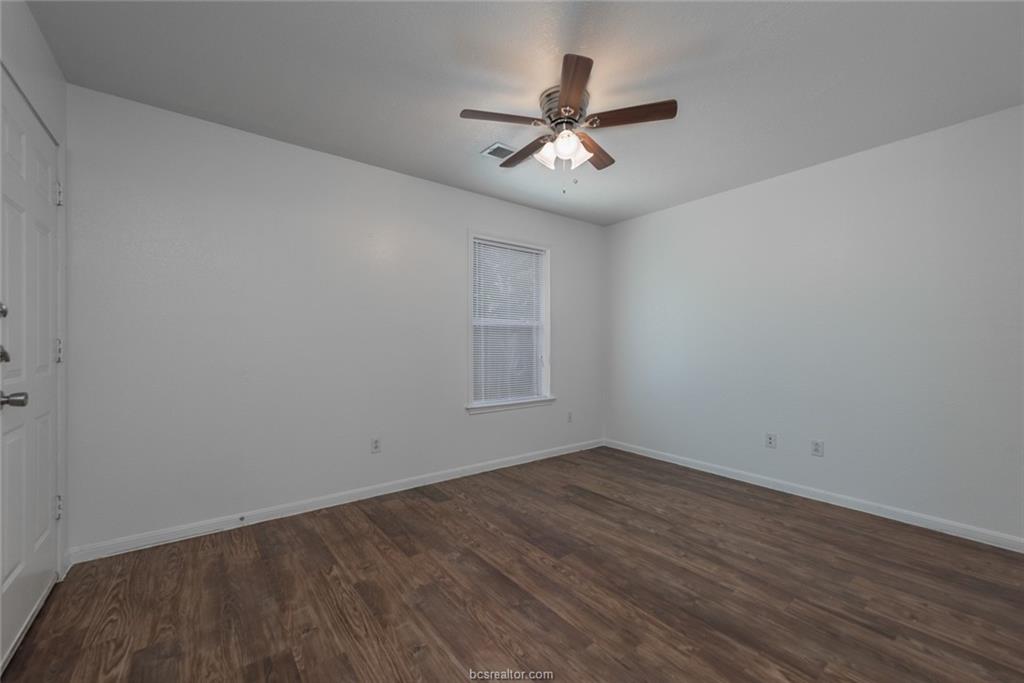 1715 Rock Hollow Loop Bryan, TX 77807 - Photo 10 of 13 a view of a big room with wooden floor and windows