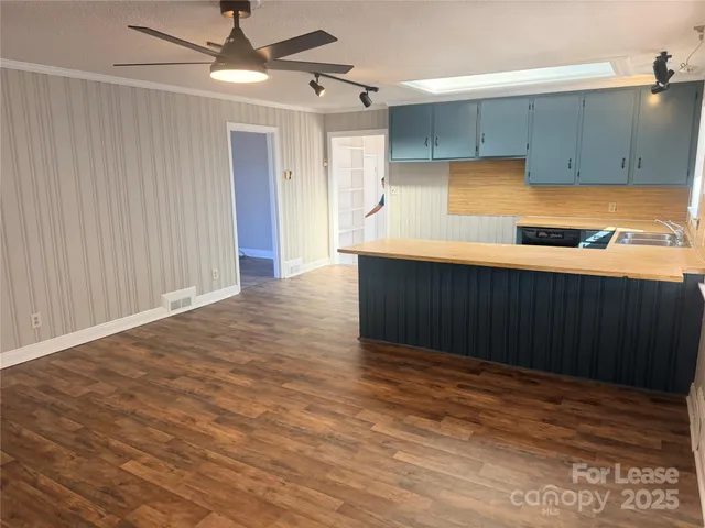 a kitchen with stainless steel appliances a refrigerator and a cabinets