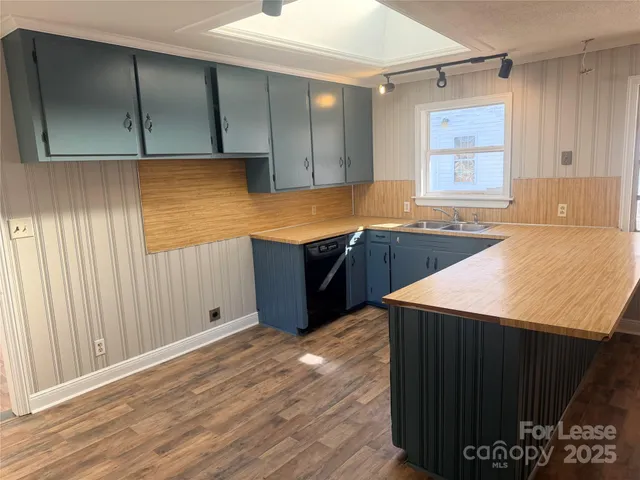a kitchen with stainless steel appliances granite countertop cabinets and wooden floor