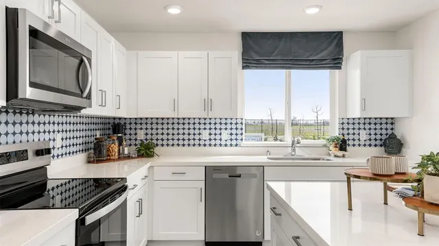 a kitchen with a sink cabinets and window