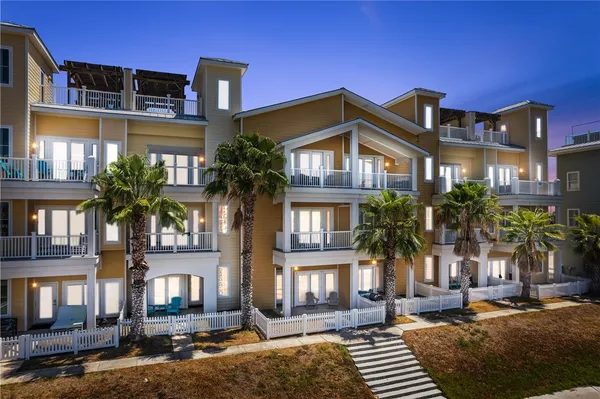 a front view of a residential apartment building with a yard