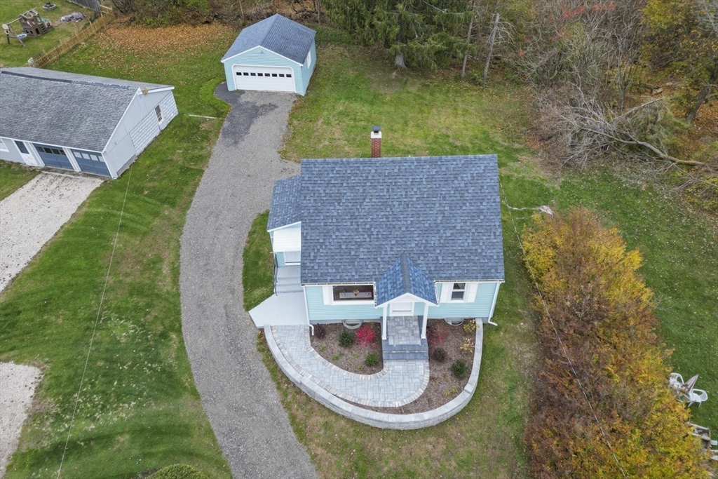an aerial view of a house with a garden and swimming pool